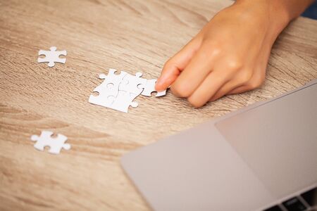 Business success concept, woman makes up puzzle