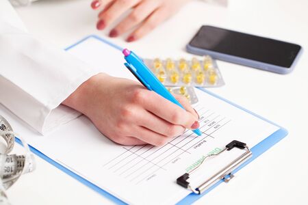 Diet concept, nutritionist makes a plan of proper nutrition.の写真素材