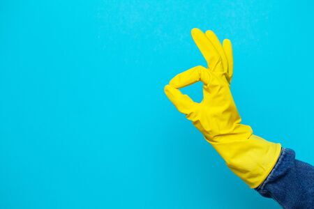 Hand in a yellow glove for cleaning.