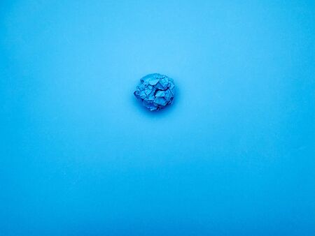 Successful idea concept, crumpled sheet of paper on blue background.の写真素材