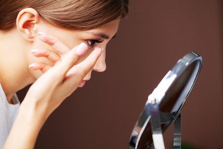 Contact lenses for vision. Close up of woman applying contact lenses.の写真素材