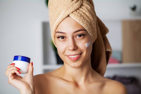 Skin care, young woman with beauty face use facial skin creamの写真素材