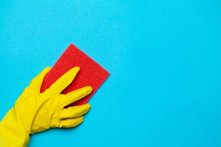 Close up hand in yellow glove for cleaning.