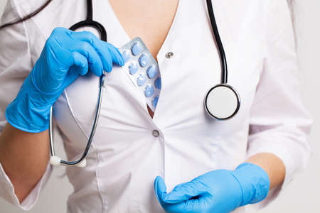 Doctor holds a pill for men's sexual health.の写真素材