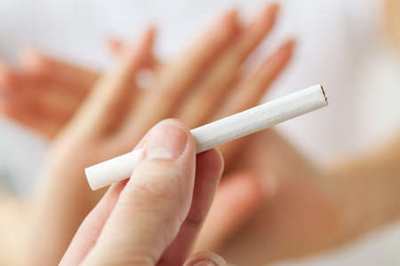 Stop smoking, close up of woman breaking cigaretteの写真素材