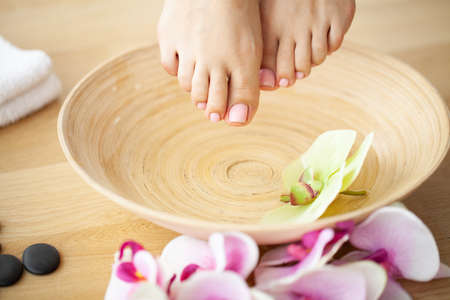Closeup photo of a female feet at spa salon on pedicure procedureの写真素材