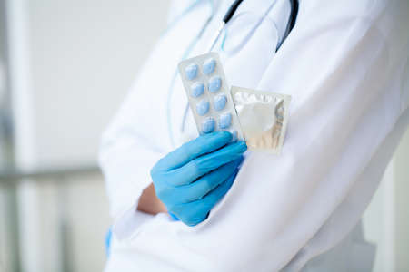 Close up of female doctor holding pill for men healthの写真素材