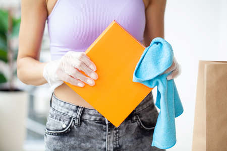 Woman disinfects parcels before unpacking at home.の写真素材