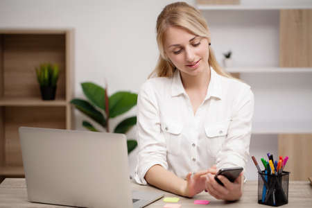 Young woman working at lap top in the office.の写真素材