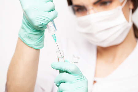 Hands of the doctors filling a syringeの写真素材