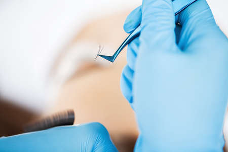 Eyelash Extension Procedure, Professional stylist lengthening female lashes.の写真素材