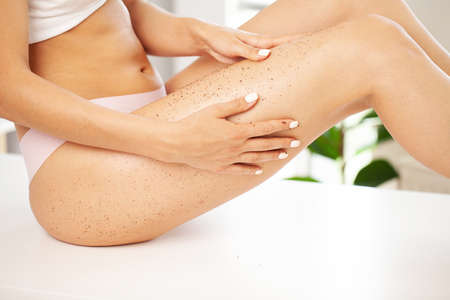 Closeup woman legs with coffee massage scrub