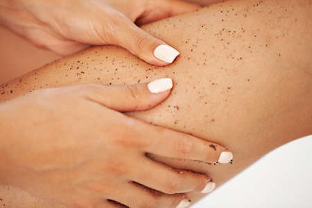 Closeup woman legs with coffee massage scrubの写真素材