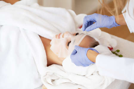 Skin care, beautiful woman with facial mask at beauty salonの写真素材
