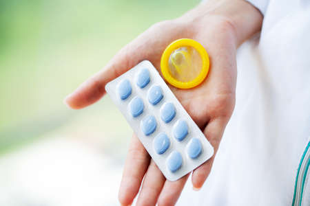 Close up of female doctor holding pill for men healthの写真素材