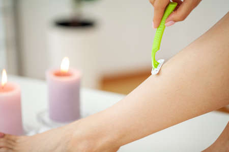 Skin care and health, women hair removal shaving legs with razor.の写真素材