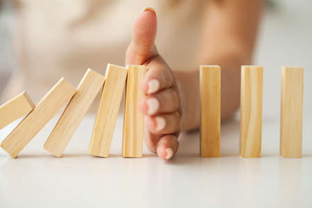 Hand putting and stacking blank wooden cubes on table with copy space for input wording and infographic icon.の写真素材