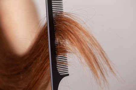 Woman with a comb in her hand on dressing room.の写真素材