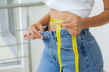 Diet, Sporty Woman Showing How Much Weight She Lost.