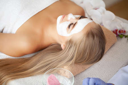 Spa Woman applying Facial cleansing Mask, Beauty Treatmentsの写真素材