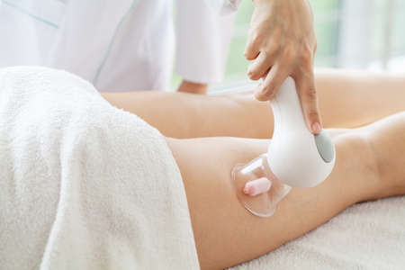 Woman getting LPG massage for skin care in homeの写真素材