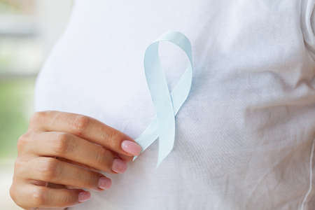 Woman with blue ribbon, prostate cancer awarenessの写真素材