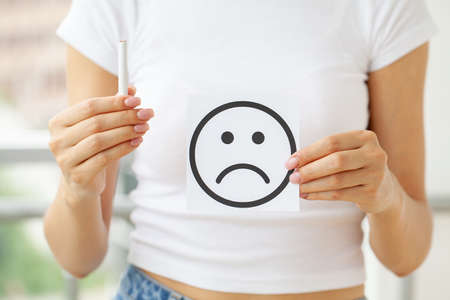 Stop smoking, young woman holding a cigaretteの写真素材