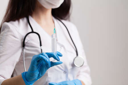 Physician hand with syringe for injection, vaccination.の写真素材