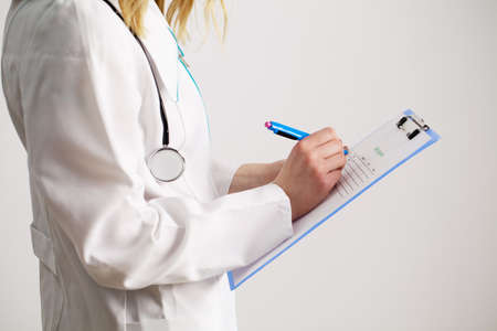 Nutritionist prepares a diet plan for an overweight womanの写真素材