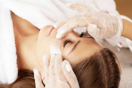 Young woman getting spa massage treatment at beauty spa salonの写真素材