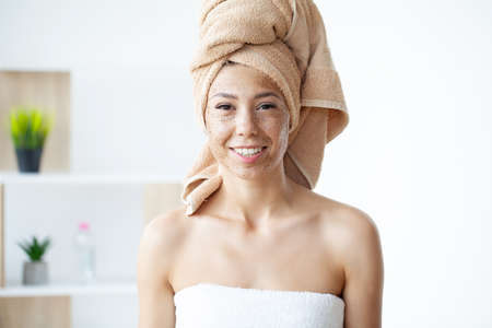 Applying coffee mask with brush at homeの写真素材