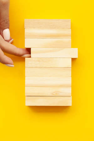 Closeup image of hands showing blank wooden cube blocksの写真素材