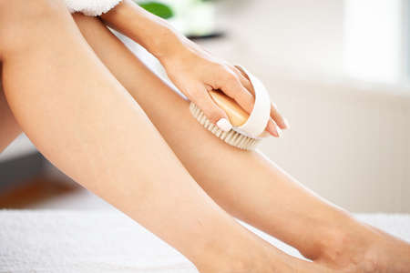 Closeup photo of young woman making a scrub massageの写真素材