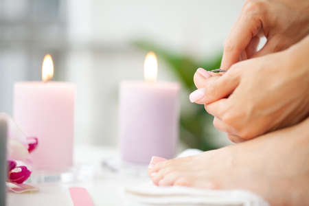 Close up woman making pedicure at her bathroomの写真素材