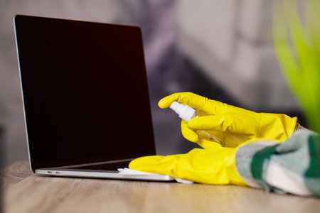 Young Smiling Woman in Yellow Gloves Cleaning Houseの写真素材