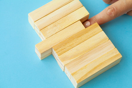 Woman hand stacked wooden blocks with space for text