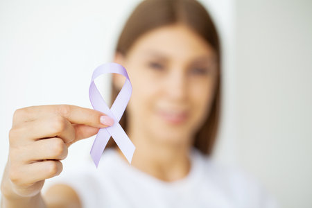 Woman holding purple ribbon, domestic violence awarenessの写真素材