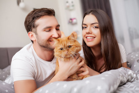 Happy sensual young couple lying in bed togetherの写真素材