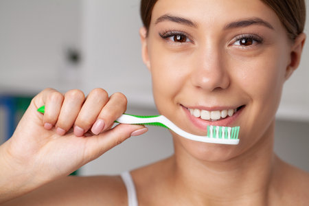 Happy Lady Brushing Teeth With Toothbrush Standing In Bathroom.の写真素材