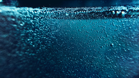 Blue water background with bubbles. Closeup photoの写真素材