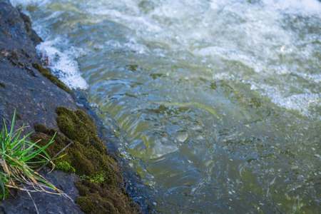 Waterflow. Water flowing over the rock. Mountain riverの写真素材