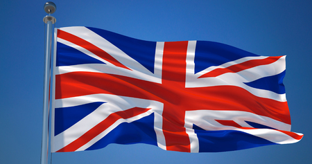 Fluttering silk flag of United Kingdom. Union Jack in the wind against clear blue skyの写真素材