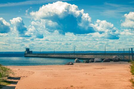 Red sand on the beach with sea pear on blue sky background. Travel landscapeの写真素材