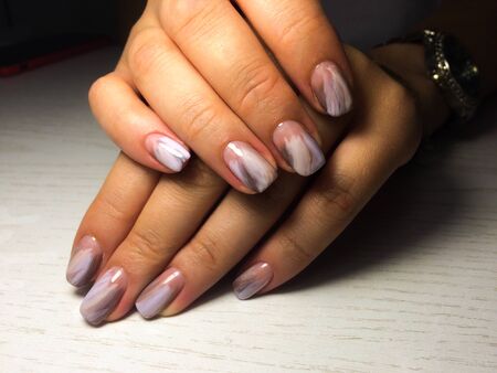 Nails care. Woman hands with  manicure on dark background. Closeup photo. Healthcare. Spaの写真素材