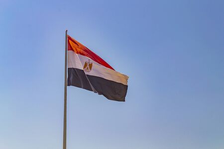 Flag of Egypt on flagpole against clear blue sky. Sharm-el-Sheikh, Egyptの写真素材