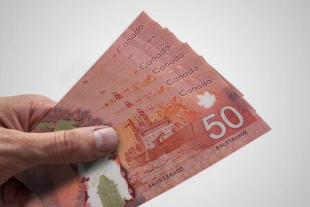 Hand holding Canadian dollars. CAD. Currency of Canadaの写真素材