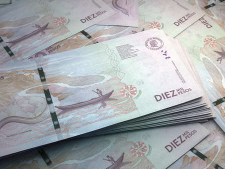 Money of Colombia. Colombian peso bills. COP banknotes. 10 pesos. Business, finance, news background.の写真素材