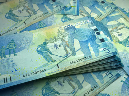 Money of Canada. Canadian dollar bills. CAD banknotes. 5 dollars. Business, finance, news background.の写真素材
