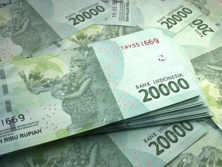 Money of Indonesia. Indonesian rupiah bills. IDR banknotes. 20,000 rupiahs. Business, finance, news background.の写真素材