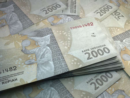 Money of Indonesia. Indonesian rupiah bills. IDR banknotes. 2000 rupiahs. Business, finance, news background.の写真素材